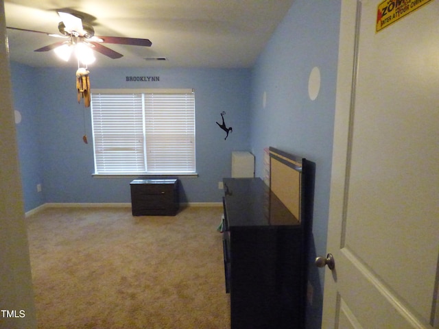 carpeted bedroom featuring visible vents, ceiling fan, and baseboards