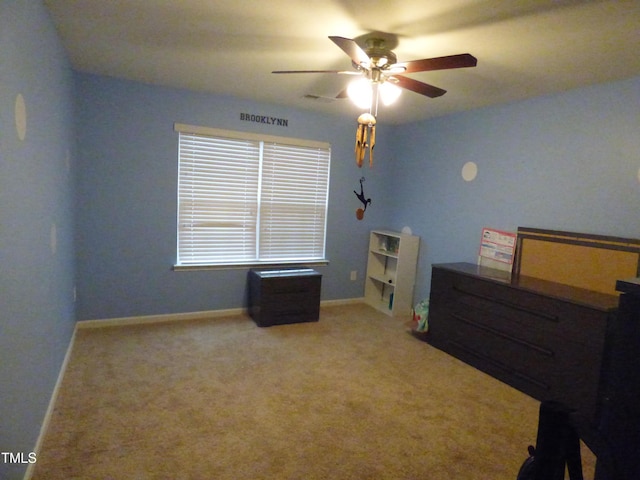 carpeted bedroom featuring a ceiling fan, visible vents, and baseboards