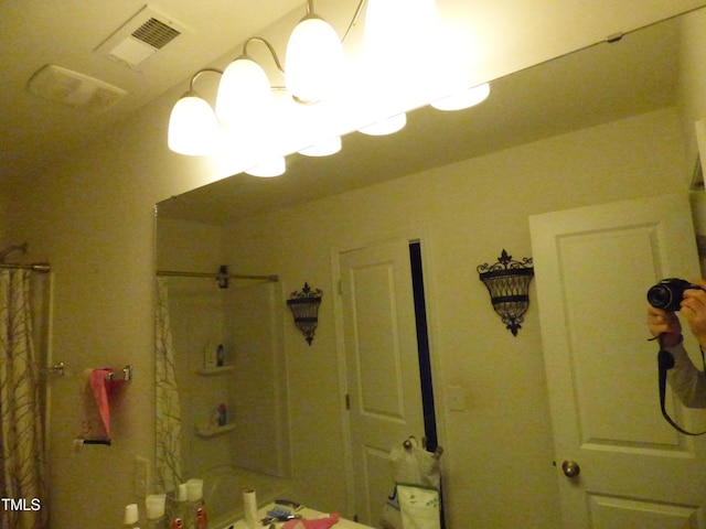 bathroom with visible vents and a shower with shower curtain