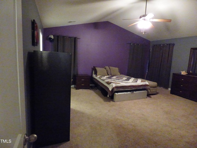 carpeted bedroom featuring lofted ceiling and a ceiling fan