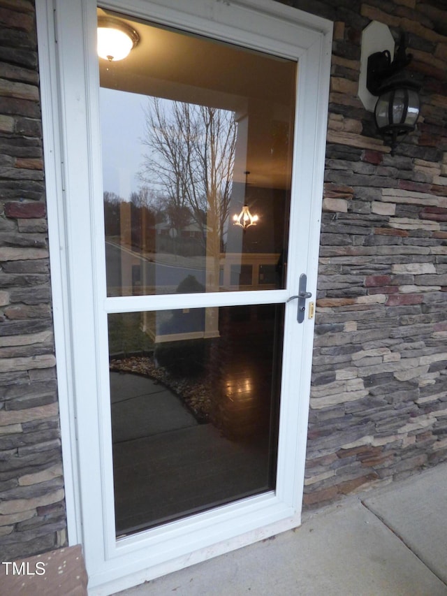 doorway to property with stone siding