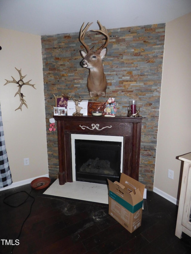 details with a fireplace, baseboards, and wood finished floors