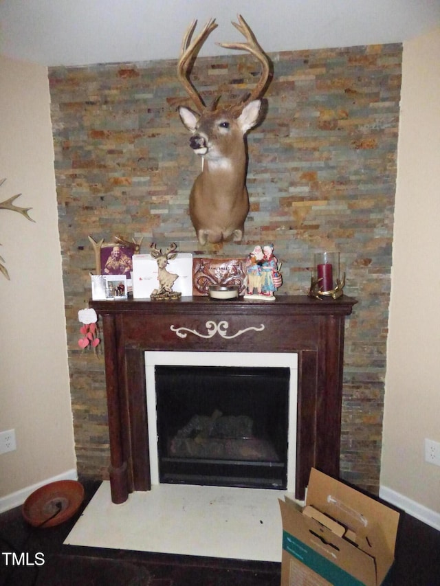 interior details with a fireplace and baseboards