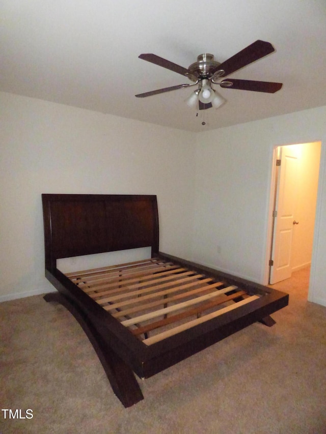 carpeted bedroom with ceiling fan and baseboards