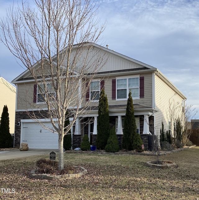 401 Lawton Dr, Haw River, NC 27258 - view of front of house with stone siding, an attached garage, driveway, and a front lawn