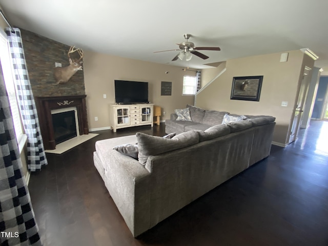 401 Lawton Dr, Haw River, NC 27258 - living room featuring a ceiling fan, a fireplace with flush hearth, dark wood-type flooring, and baseboards
