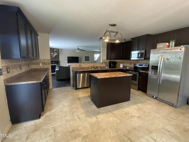 401 Lawton Dr, Haw River, NC 27258 - kitchen featuring stainless steel appliances, tasteful backsplash, open floor plan, a center island, and ceiling fan