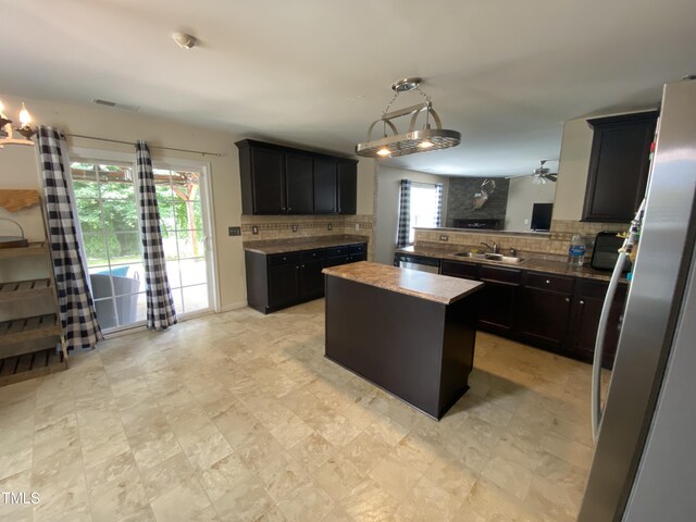 401 Lawton Dr, Haw River, NC 27258 - kitchen featuring a sink, tasteful backsplash, stainless steel appliances, and plenty of natural light