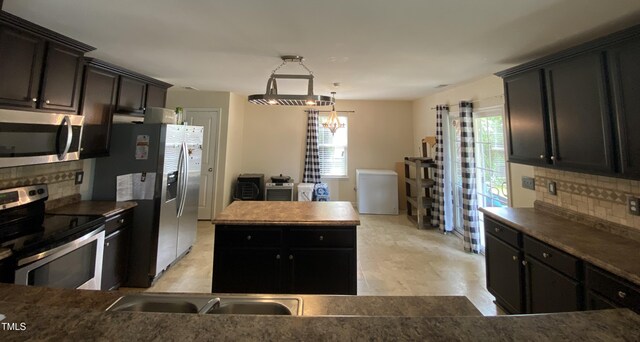 401 Lawton Dr, Haw River, NC 27258 - kitchen featuring appliances with stainless steel finishes, tasteful backsplash, and healthy amount of natural light