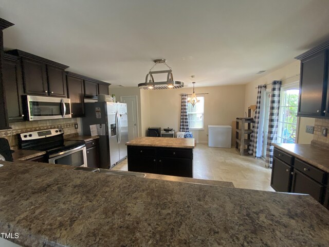 401 Lawton Dr, Haw River, NC 27258 - kitchen featuring appliances with stainless steel finishes, backsplash, and healthy amount of natural light