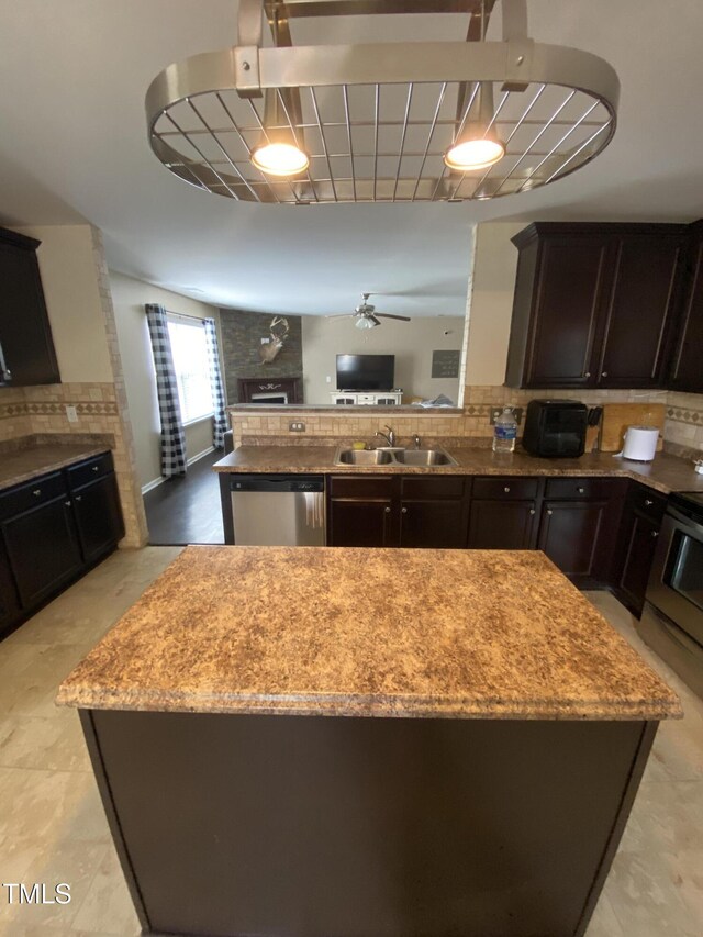 401 Lawton Dr, Haw River, NC 27258 - kitchen with stainless steel dishwasher, a fireplace, a sink, electric stove, and tasteful backsplash