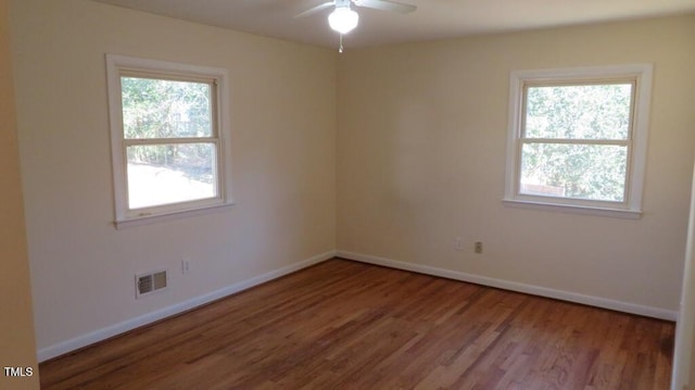 unfurnished room with hardwood / wood-style floors, ceiling fan, and plenty of natural light