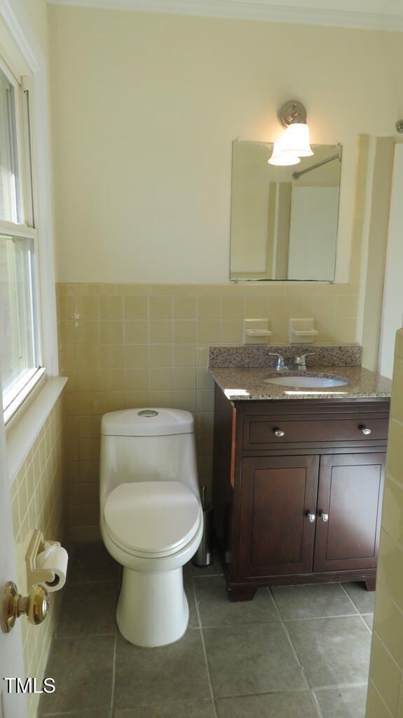 bathroom featuring tile walls, tile patterned flooring, and vanity