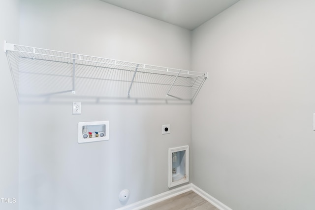 laundry area with gas dryer hookup, washer hookup, hardwood / wood-style flooring, and hookup for an electric dryer