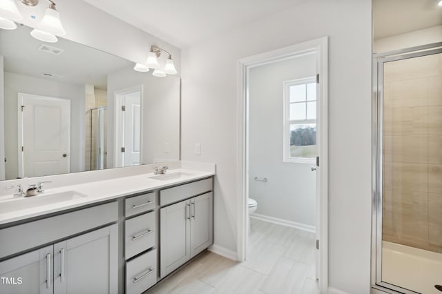 bathroom featuring toilet, walk in shower, and vanity