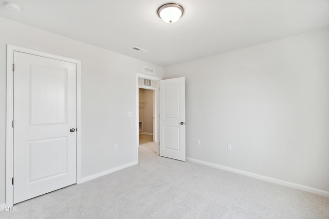 unfurnished bedroom with light colored carpet