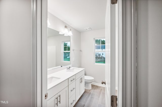 bathroom featuring vanity and toilet