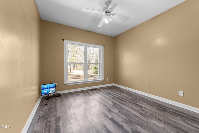 empty room with ceiling fan and hardwood / wood-style floors