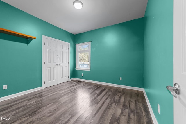 unfurnished bedroom featuring a closet and hardwood / wood-style floors