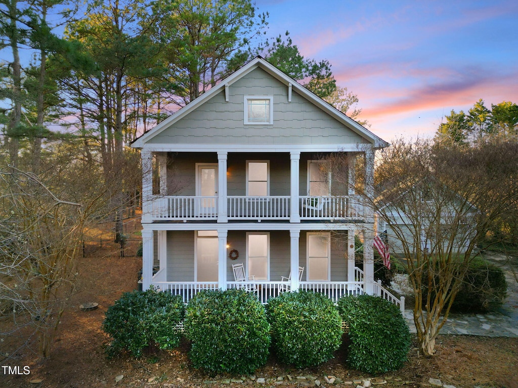 view of front facade featuring covered porch and a balcony