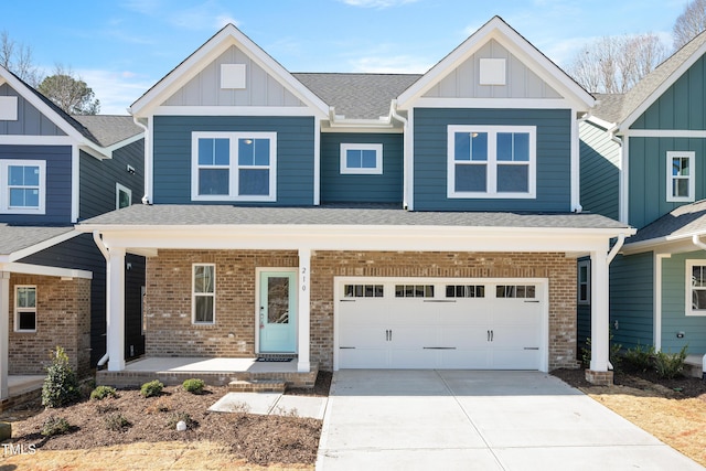 craftsman inspired home featuring board and batten siding, covered porch, brick siding, and concrete driveway