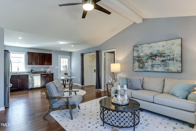 living room with hardwood / wood-style floors, vaulted ceiling with beams, a barn door, and ceiling fan