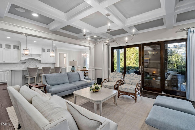 living room featuring beam ceiling, crown molding, coffered ceiling, and hardwood / wood-style floors