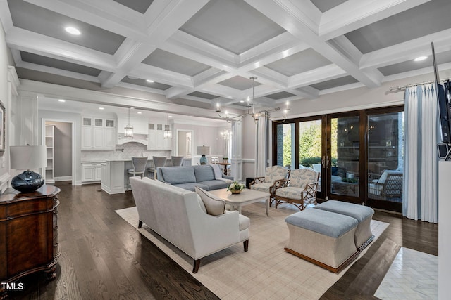 living room with beamed ceiling, coffered ceiling, a chandelier, and hardwood / wood-style floors