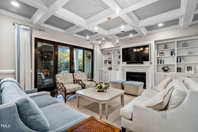 living room featuring a high end fireplace, built in shelves, beamed ceiling, a chandelier, and coffered ceiling