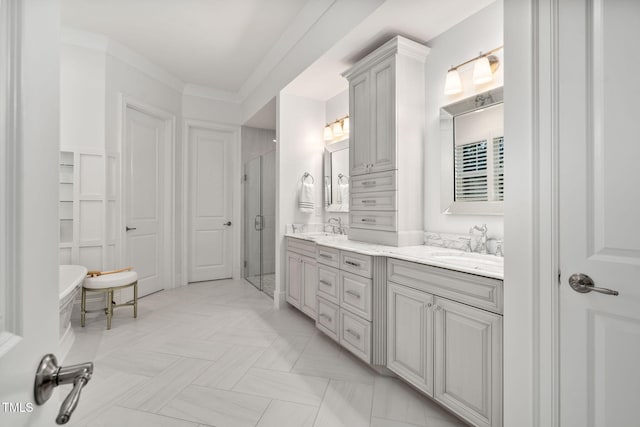 bathroom featuring crown molding, a shower with shower door, and vanity