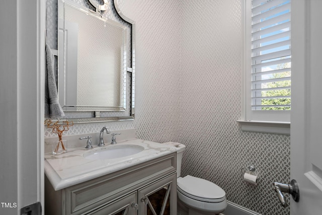 bathroom featuring toilet and vanity