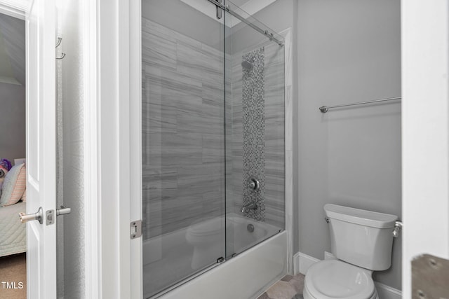 bathroom featuring shower / bath combination with glass door and toilet