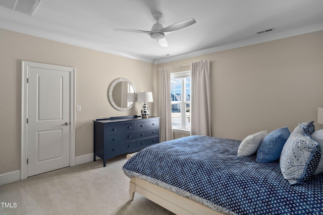 bedroom featuring ceiling fan, light carpet, and crown molding