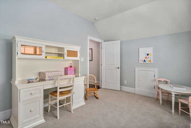 home office with light carpet and lofted ceiling