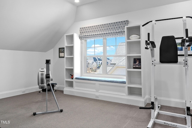 workout area featuring vaulted ceiling and carpet flooring