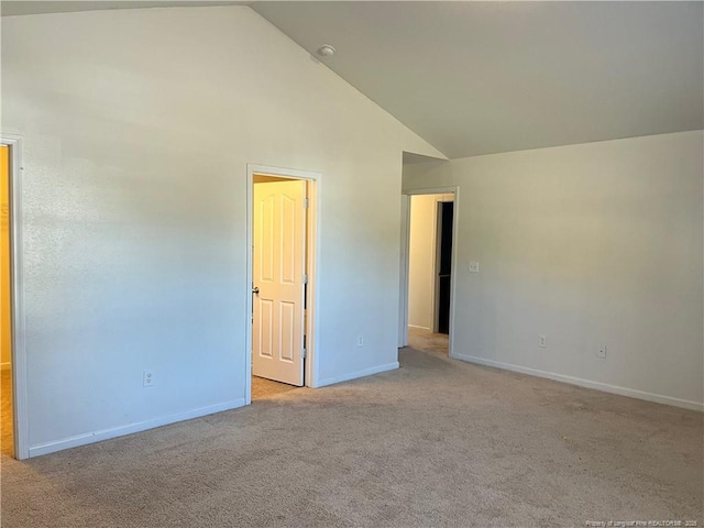 unfurnished room featuring high vaulted ceiling and light carpet