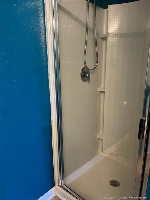 bathroom featuring a shower stall