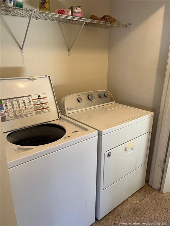washroom featuring separate washer and dryer and laundry area