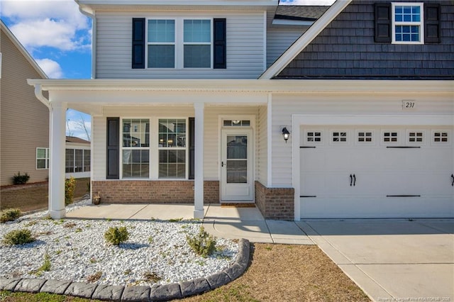 view of front of house featuring a porch and a garage