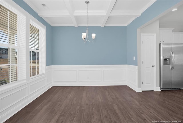 unfurnished dining area featuring an inviting chandelier, beamed ceiling, ornamental molding, dark hardwood / wood-style floors, and coffered ceiling