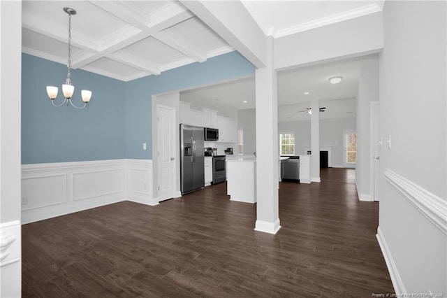 unfurnished living room featuring ceiling fan with notable chandelier, coffered ceiling, dark hardwood / wood-style flooring, crown molding, and beam ceiling