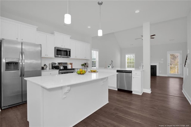 kitchen with stainless steel appliances, white cabinetry, ceiling fan, and kitchen peninsula