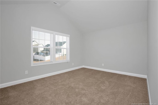 spare room with lofted ceiling and carpet flooring