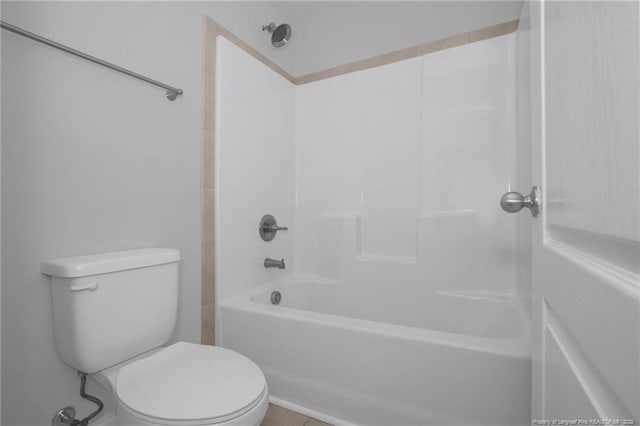 bathroom with shower / washtub combination and toilet