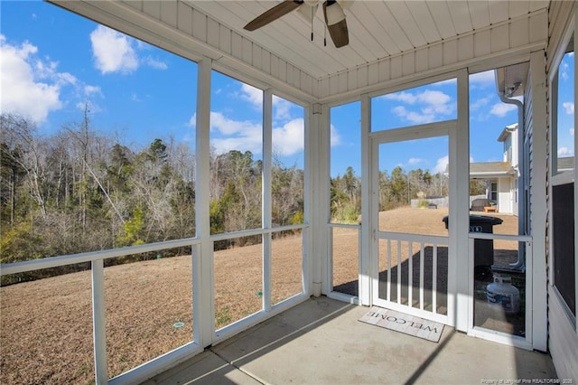 unfurnished sunroom with ceiling fan and plenty of natural light