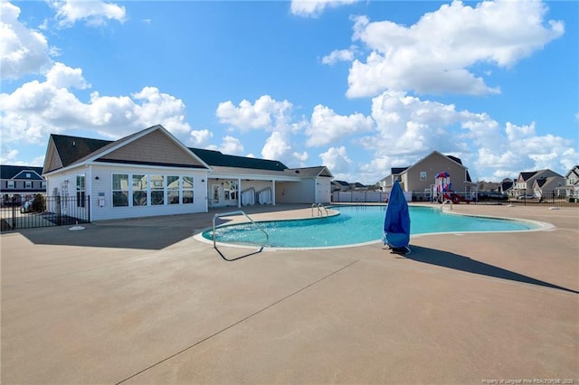 view of pool featuring a playground and a patio