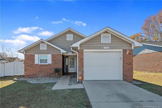 view of front of home featuring a garage and a front lawn