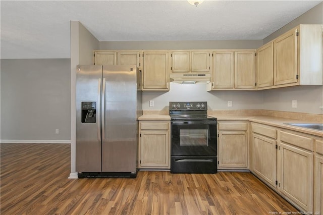 kitchen with black / electric stove, dark hardwood / wood-style floors, stainless steel fridge, light brown cabinets, and sink