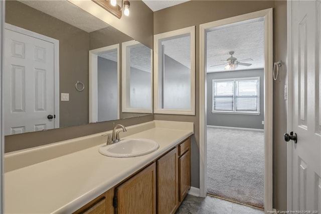 bathroom with vanity, a textured ceiling, and ceiling fan