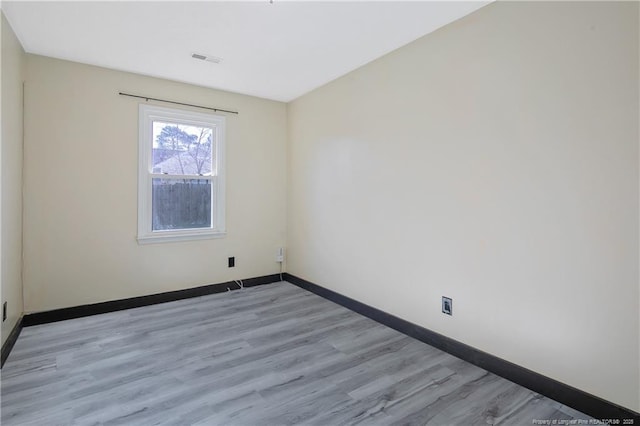 unfurnished room featuring light wood-type flooring